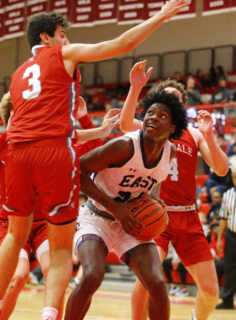 Oswego East's Mekhi Lowery (24) looks for an open shot during the Hinsdale Central Holiday Classic championship game between Oswego East and Hinsdale Central high schools on Thursday, Dec. 29, 2022 in Hinsdale, IL.