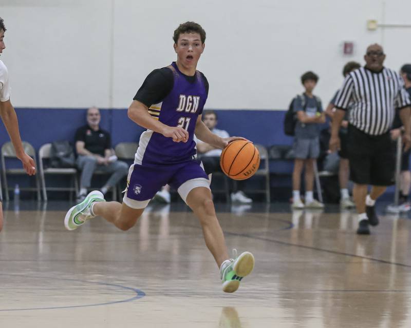 Downers Grove North's Jack Romsey (21) advances the ball down the court in their Riverside-Brookfield Shootout basketball game.  June 20, 2025 in Riverside.