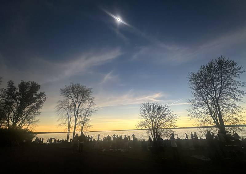 Hundreds of people view the total solar eclipse from Rend Lake near Whittington on Monday, April 8, 2024.