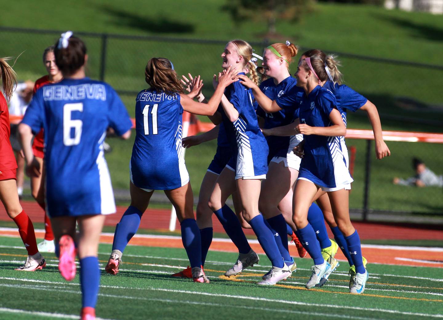 Geneva celebrates a goal by teammate Olivia Pohlman (center) during a Tri-Cities Soccer Night game against Batavia on Tuesday, April 29, 2025 at St. Charles East.