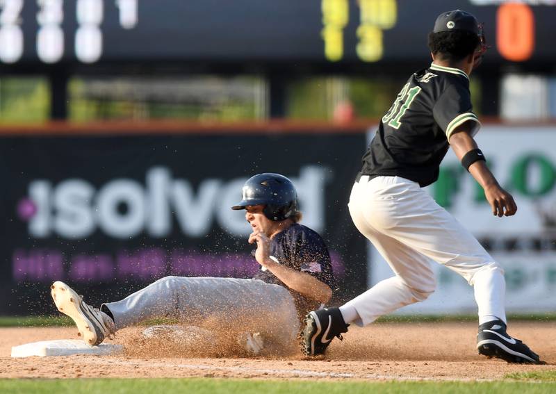 Cary-Grove's Brock Iverson slides into third base at the head end of a double steal as St. Patrick third baseman Gaston Lopez takes the throw during the Class 3A supersectional baseball game at Wintrust Field on Monday, June 9, 2025 in Schaumburg.