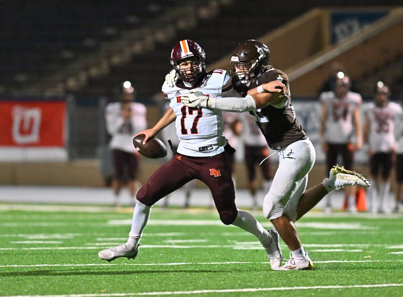 Joliet Catholic's Jeremy Johnson (22) sacks Brother Rice's Ryan Hartz (17) in overtime on Friday, Oct. 07, 2022, at Joliet Memorial Stadium. (Dean Reid for Shaw Media)