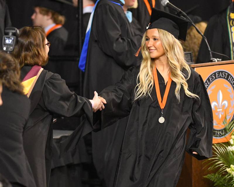 A St. Charles East graduate accepts her diploma on Monday, May 18, 2026, at the Convocation Center in DeKalb.