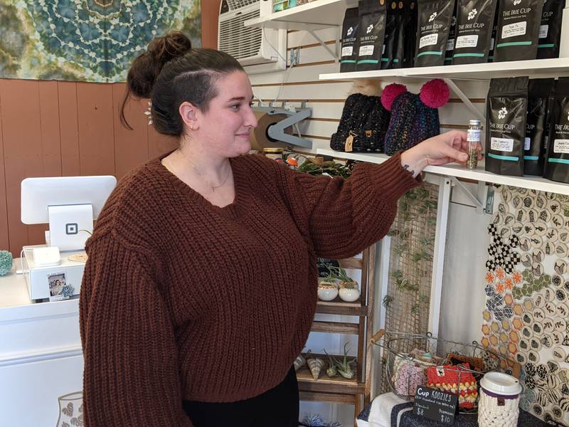 Dirty Clay Co. owner Megan Wilson arranges items at her store in Batavia. The store saw brisk business on Small Business Saturday.