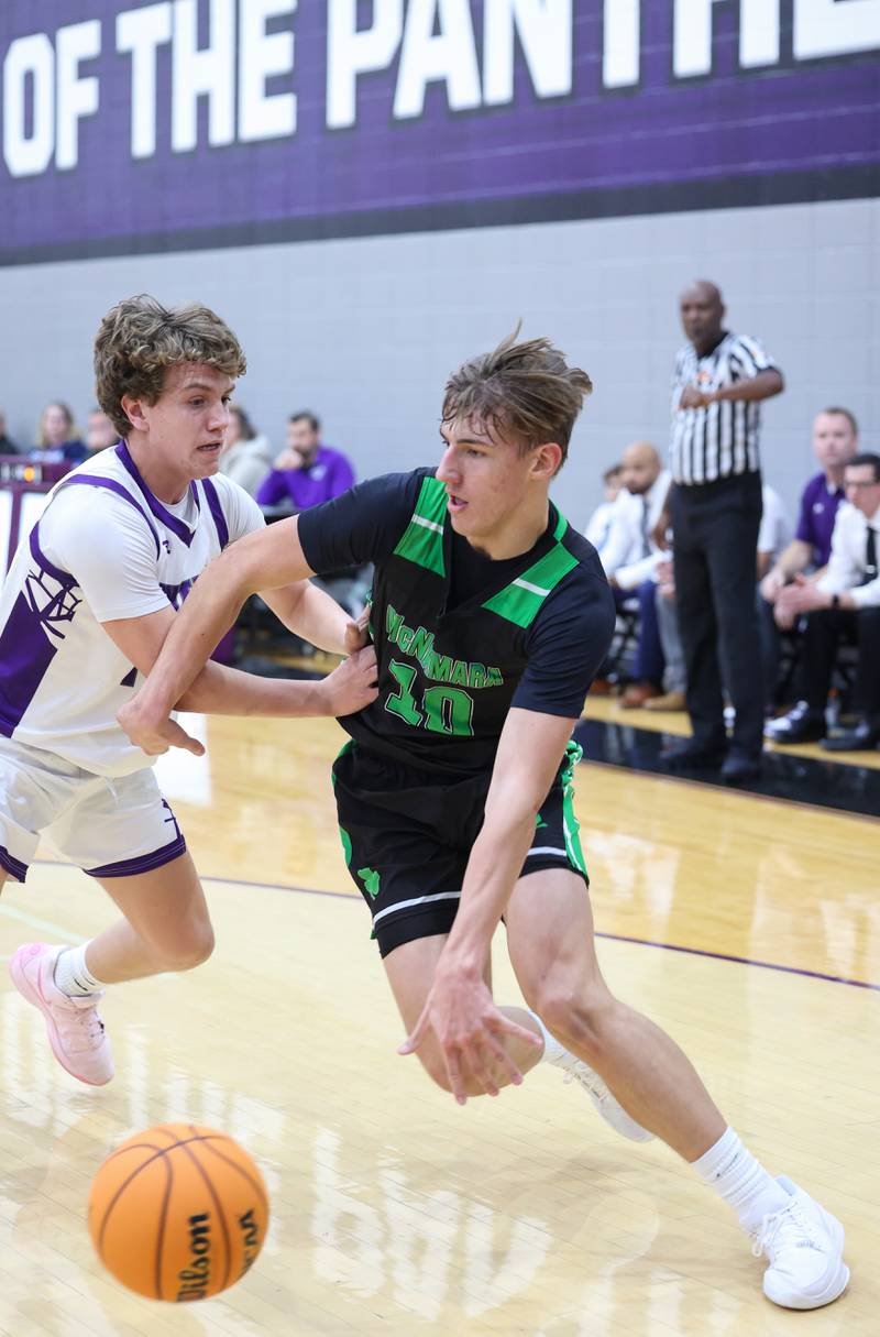 Bishop McNamara's Coen Demack drives to the lane against Manteno's Jack Gotkowski during the Fightin' Irish's 61-24 victory over Manteno on Tuesday, Jan. 13, 2026.