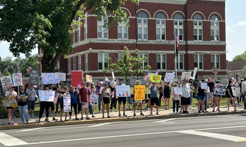 Attendees at the "No Kings" rally held in Oregon, Illinois on Saturday, June 14, 2025 hold their signs critical of the actions by President Donald Trump. An estimated 500 people attended the event.