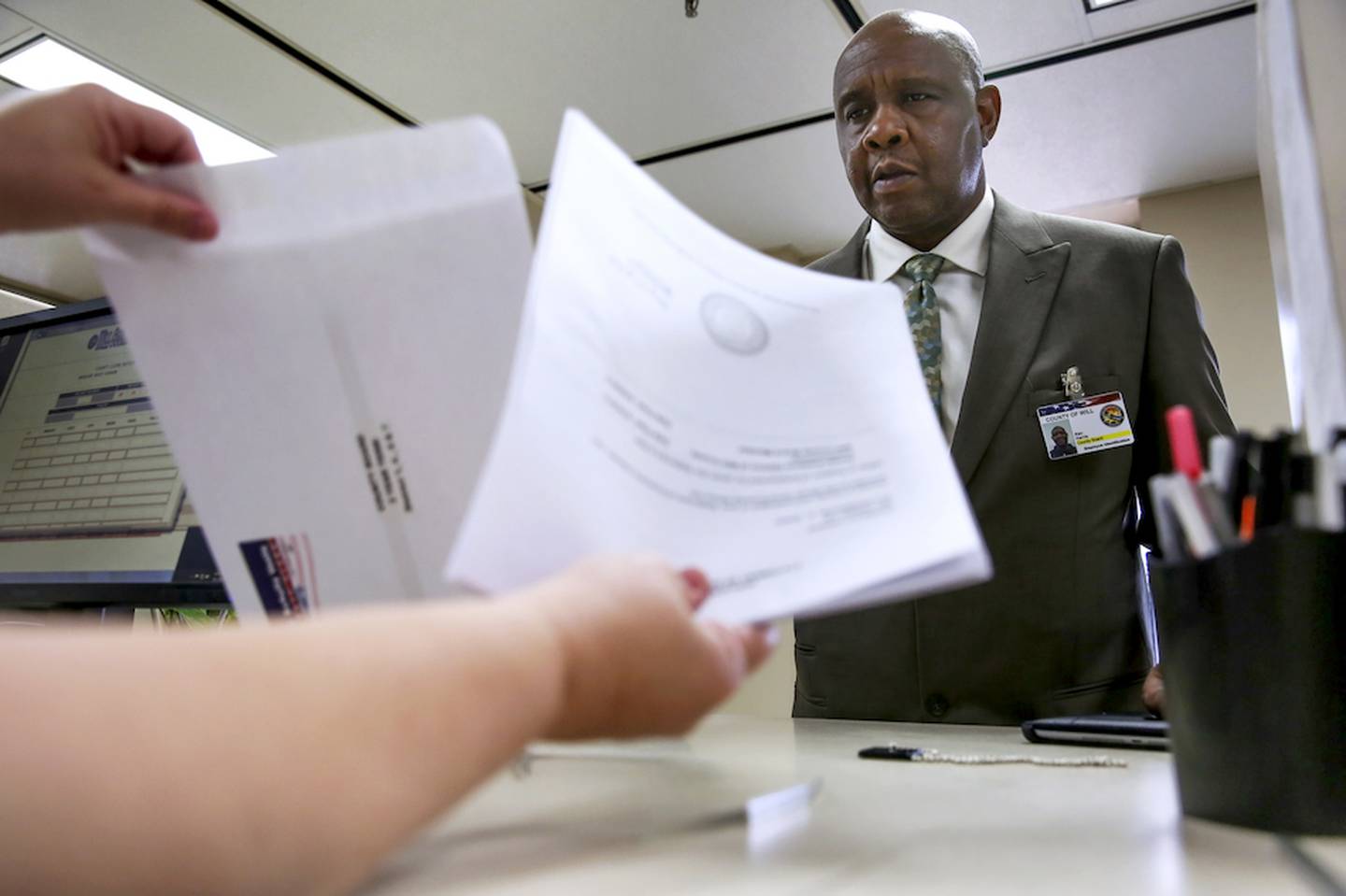 Will County Board member Kenneth Harris picks up campaign information Tuesday at the County Clerk's Office in Joliet. Tuesday was the first day candidates could pick up petition information for the March primary.