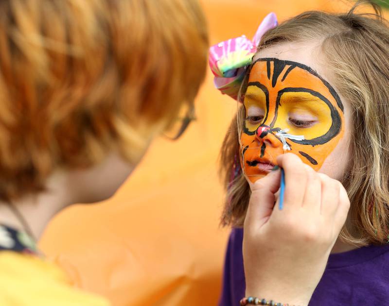 Arabella Bishop, 4, from Dekalb, gets her face painted by Cedar Laliberta, from DeKalb, during the Pride Palooza Friday, May 30, 2025, at Bethlehem Lutheran Church in DeKalb. The event was hosted by Family Service Agency of DeKalb County and Youth Outlook.