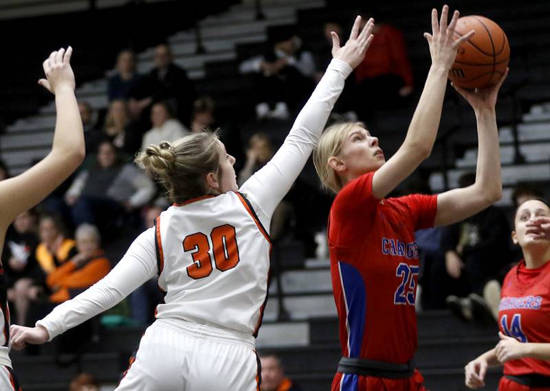 Dundee-Crown’s Monica Sierzputowski drives to the basket against McHenry's Ali Ahrens during a Fox Valley Conference girls basketball game on Tuesday, Dec. 12, 2023, at McHenry High School.
