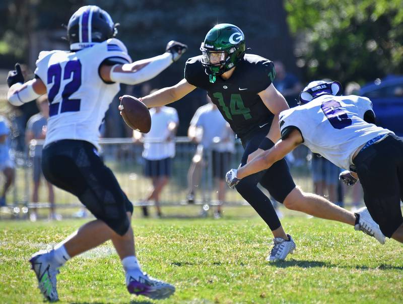 Glenbard West quarterback Charlie Cline (14) tries in vain to evade the sack of Downers Grove North's Theodore Griffin (6) during a game on Sep. 9, 2023 at Glenbard West High School in Glen Ellyn.
Jon Cunningham for Shaw Local News Network