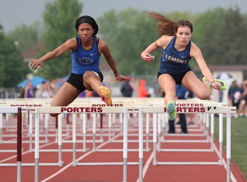 Lemont's Juliette Reyes (right) battles with Lincoln-Way East's Kendall Crossley in the 100-meter hurdles during the Class 3A Lockport Sectional on Friday, May 12, 2023.