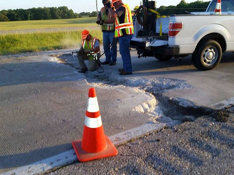 Illinois Department of Transportation crews repair a roadway after pavement buckling due to the extreme heat and rainfall in this file photo.