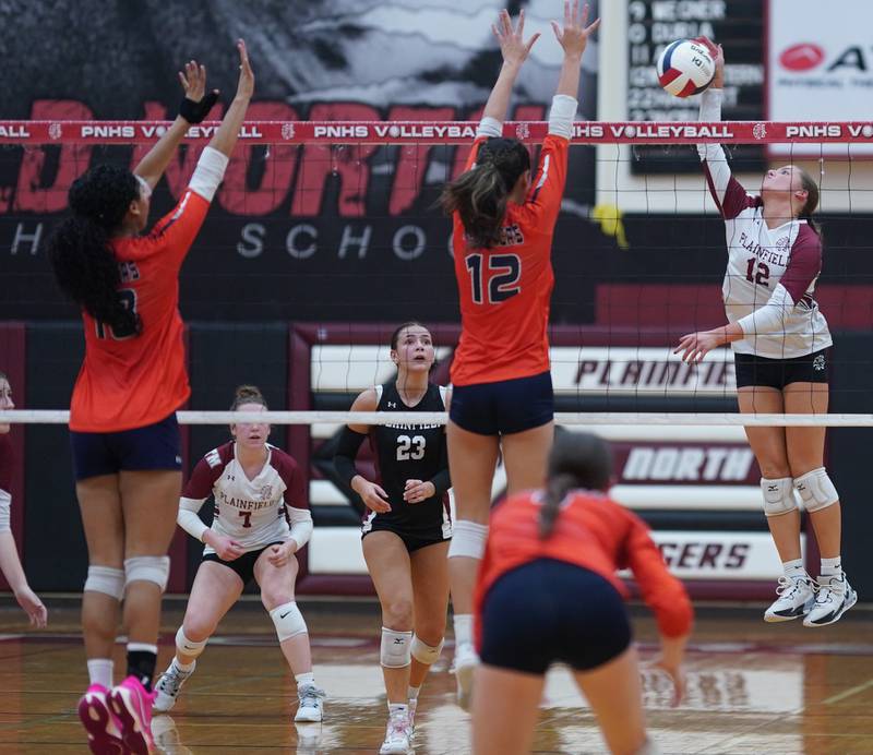 Plainfield North's Ella Maletich (right) goes up for a kill against Oswego during the class 4A Plainfield North regional volleyball final at Plainfield North High School on Thursday, Oct. 26, 2023.
