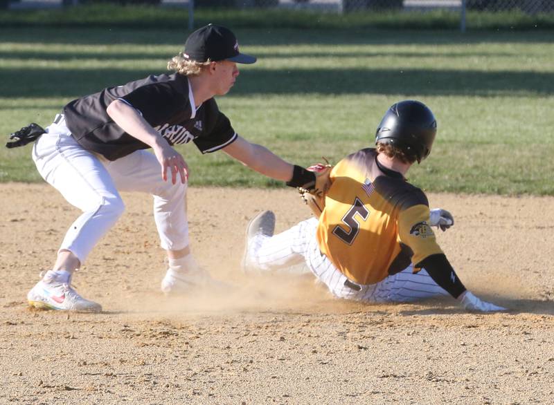 Putnam County's Drew Carlson (5) steals second base as Woodland/Flanagan-Cornell's Connor Dodge tries a catch-and-sweep tag Tuesday, April 9, 2024, at Woodland School in rural Streator.