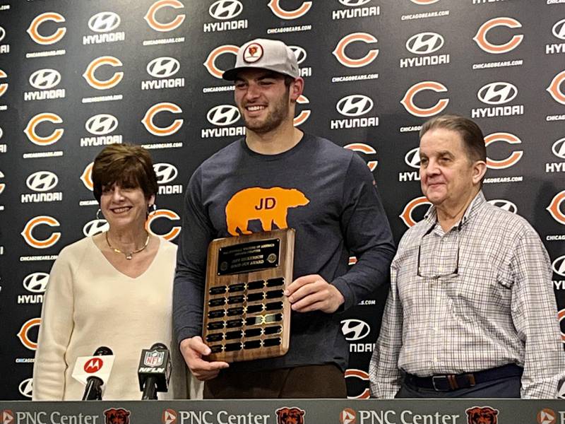 Sandy Dickerson (left) and George Dickerson (right) present Bears tight end Cole Kmet (center) with the Jeff Dickerson Good Guy Award on Wednesday at Halas Hall in Lake Forest. Kmet earned the award for his professionalism with the media this season. The annual award was renamed this year in honor of former ESPN reporter Jeff Dickerson, who died of cancer last year. Dickerson's parents were on hand to present the award.