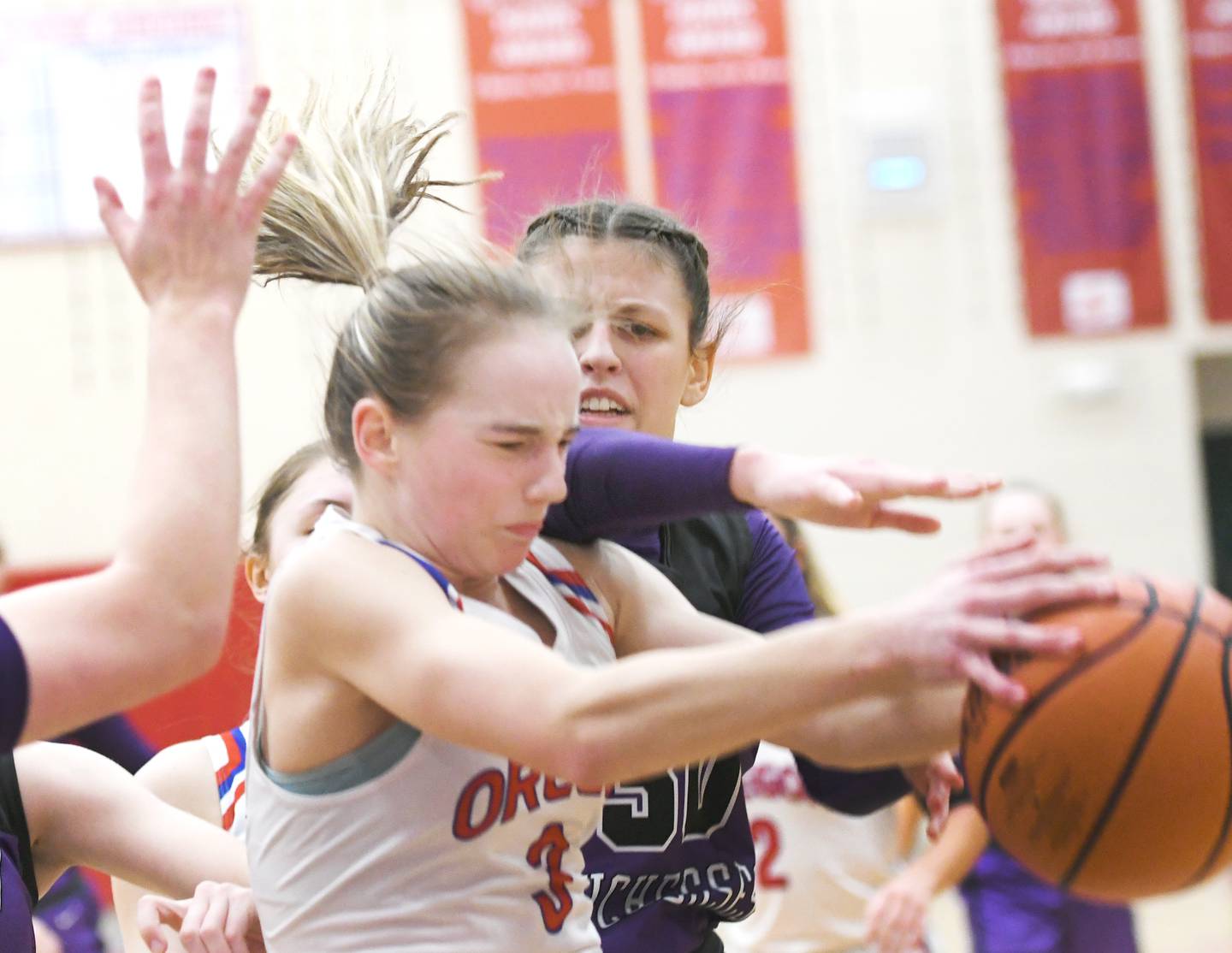 Oregon's Ella Dannhorn (3) and Dixon's Hrvest Day (30) reach for a loose ball during a Jan. 21 game at the Blackhawk Center.
