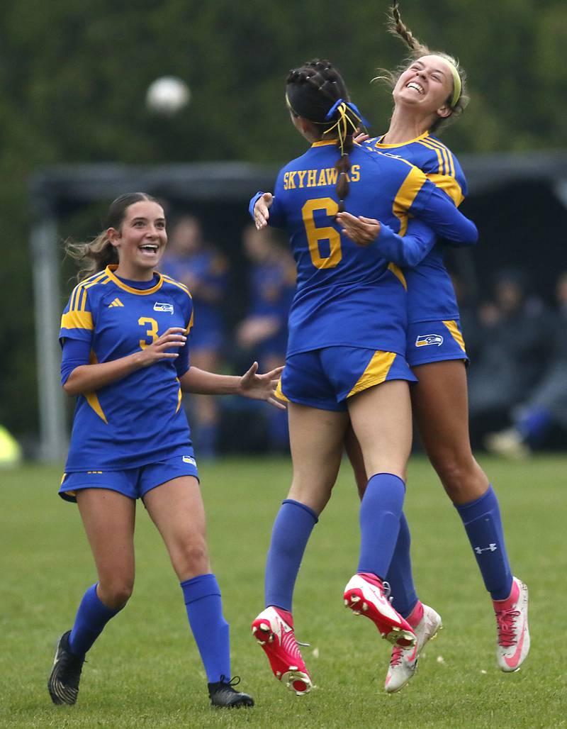 Johnsburg's Charlie Eastland (left) Liz Smith (center) and Lauren McQuiston (right) celebrate Smith’s second goal during the Class 1A Marian Central Girls Soccer Regional Championship match on Tuesday, May 20, 2025, at Marian Central High School in Woodstock.