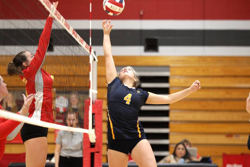 Neuqua Valley’s Sophia Kane gets the ball over the net during a game at Batavia High School on Tuesday, Aug. 29, 2023.
