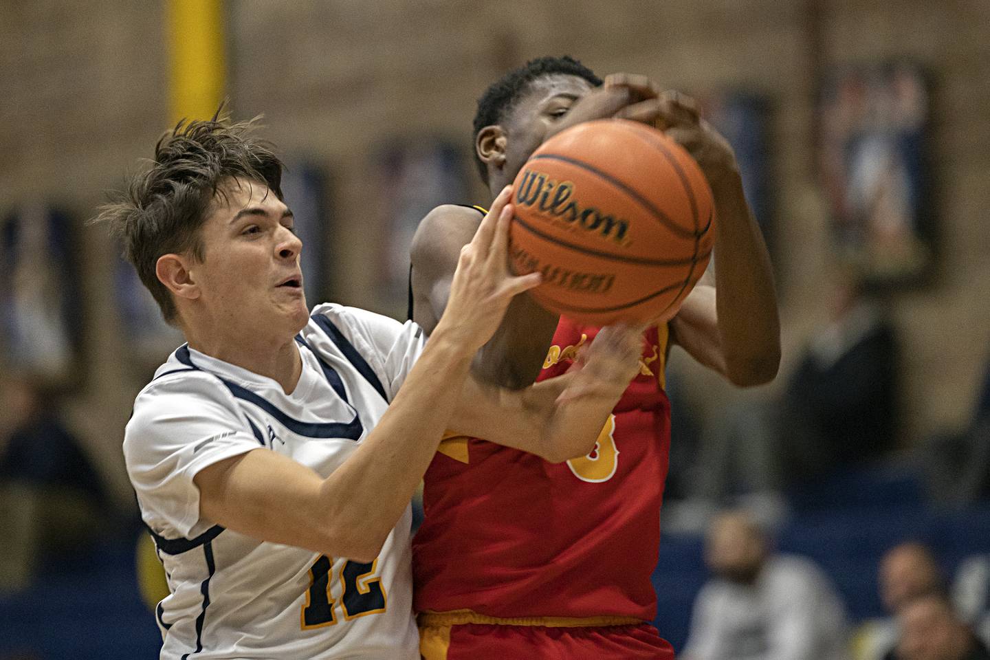 Sterling’s Carter Chance and Rock Island’s Lawson Zulu go for a rebound Tuesday, Dec. 5, 2023 at Sterling High School.