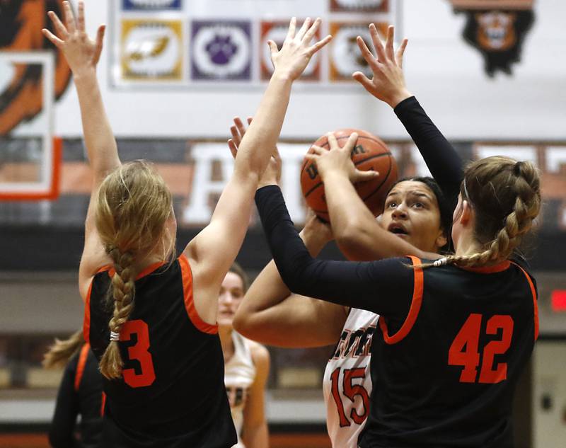 Crystal Lake Central's Taja Bryan shoots the ball between the defense of McHenry's Peyton Stinger, left, and Madalynn Friedle, right, during a Fox Valley Conference girls basketball game Tuesday, Nov.. 29, 2022, between Crystal Lake Central and McHenry at Crystal Lake Central High School.