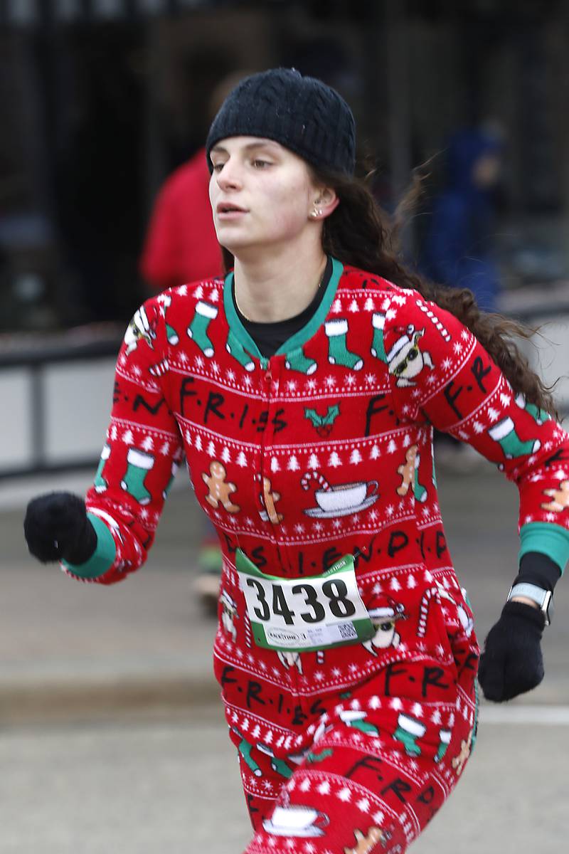 Faith Wilder runs to the finish line during the McHenry County Santa Run For Kids on Sunday morning, Dec. 3, 2023, in Downtown Crystal Lake. The annual event raises money for agencies in our county who work with children in need.
