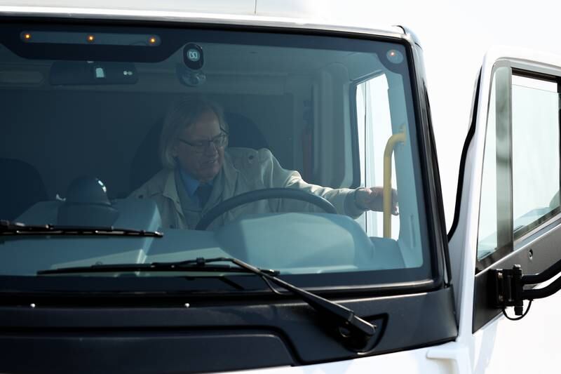 Herald-News reporter Bob Okon exits an all electric truck after taking it for a test drive during a press conference and interactive tour the new manufacturing facility.. Monday, Mar. 21, 2022, in Joliet.