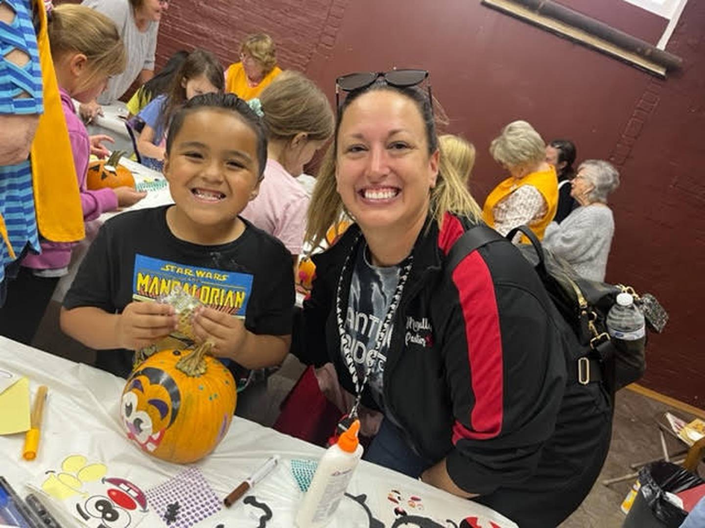 Marseilles Elementary School teacher Ms. Brooke joins her student, Jovell, during the second-graders' pumpkin decorating activity at the Seattle Sutton Marseilles Museum on Oct. 6.