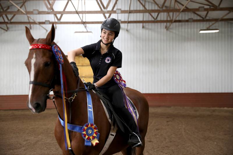 St. Charles North student Alyssa Watanapongse works with her horse, Tahlia, at Meadow Brook Stables in Maple Park. Watanapongse is a saddleseat rider and recently won ribbons in the Monarch National Championship Horse Shoe in Springfield.