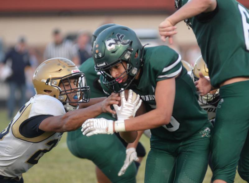 West Carroll's Roger LaBorn (3) runs for a gain as Polo's Quintin Hart (25) tries to dislodge the ball in 8-man football action in Mt. Carroll on Friday, Sept. 12, 2025.