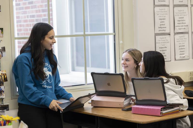 Kiralyn Fisher (left), Madelyn Oyen and Sophia Torres work on the sports spread for the yearbook Friday, Feb. 7, 2025, in Sterling High School’s Publications class. The class is in charge of the yearbook and the high school newspaper website “Warrior Word.”