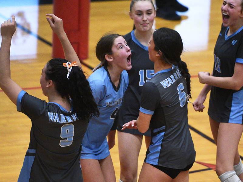 Willowbrook's Grace C Conley (4) gets teammate Hanna Kenny (6) fired up during Monday's Proviso West Class 4A girls sectional volleyball match against York in Hillside.