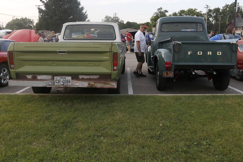 Gary Wynn of Cary looks a a 1955 Ford F100  on Wednesday July 10, 2024, during the Cary Cruise Night. The weekly car show hosted by the Cary-Grove Area Chamber of Commerce draws about 125 cars and trucks each week. The event runs weekly on Wednesday through the end of August.