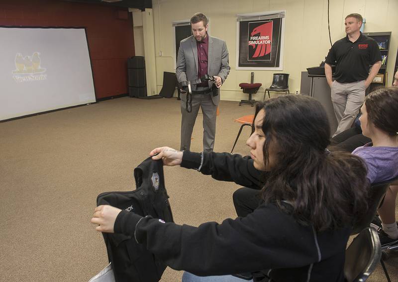 SVCC criminal justice student Emilia Aguilar of Sterling looks over Thomson Prison guard Alex Chadwick’s vest Wednesday, March 2, 2022.