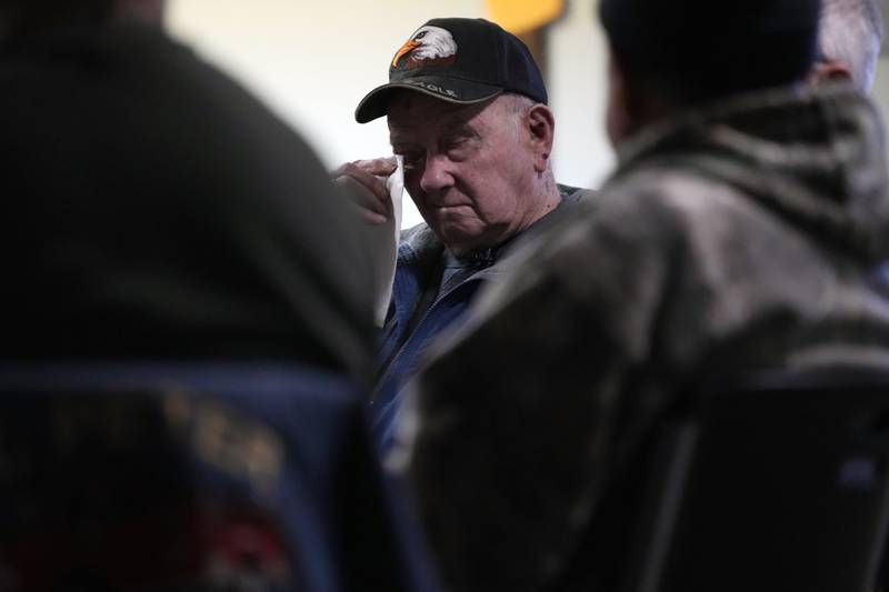 Earl Meyer, who fought for the U.S. Army in the Korean War, wipes away a tear while talking with fellow veterans at the American Legion, Tuesday, Nov. 7, 2023, in St. Peter, Minn. Meyer, 96, is suing the Army to try to get the Purple Heart medal that he says he earned when he was wounded during fierce combat in June of 1951.