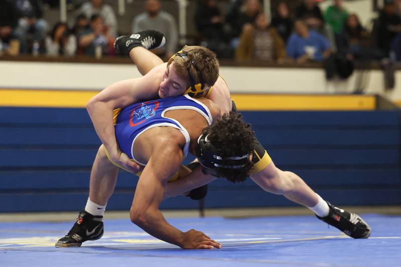 Joliet West’s Carson Weber brings down Joliet Central’s Yamil Cotto in the 150-pound weight match at Joliet Central on Friday, Jan 31, 2025.