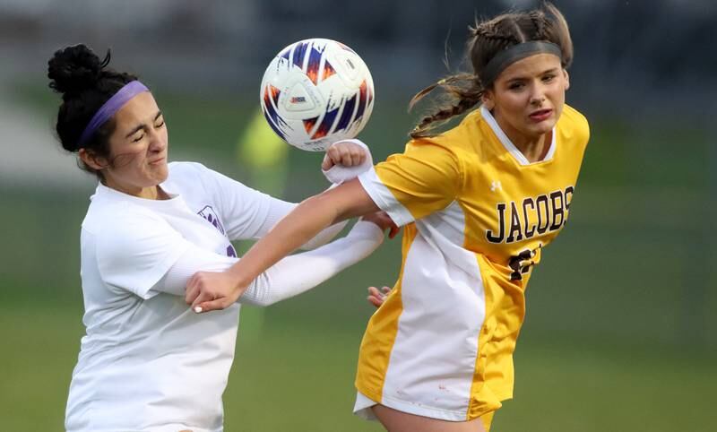 Jacobs’ Kylie Deegan, right, battles Hampshire’s Naieli Juarez  in varsity girls soccer on Thursday, April 17, 2025, at Jacobs High School in Algonquin.