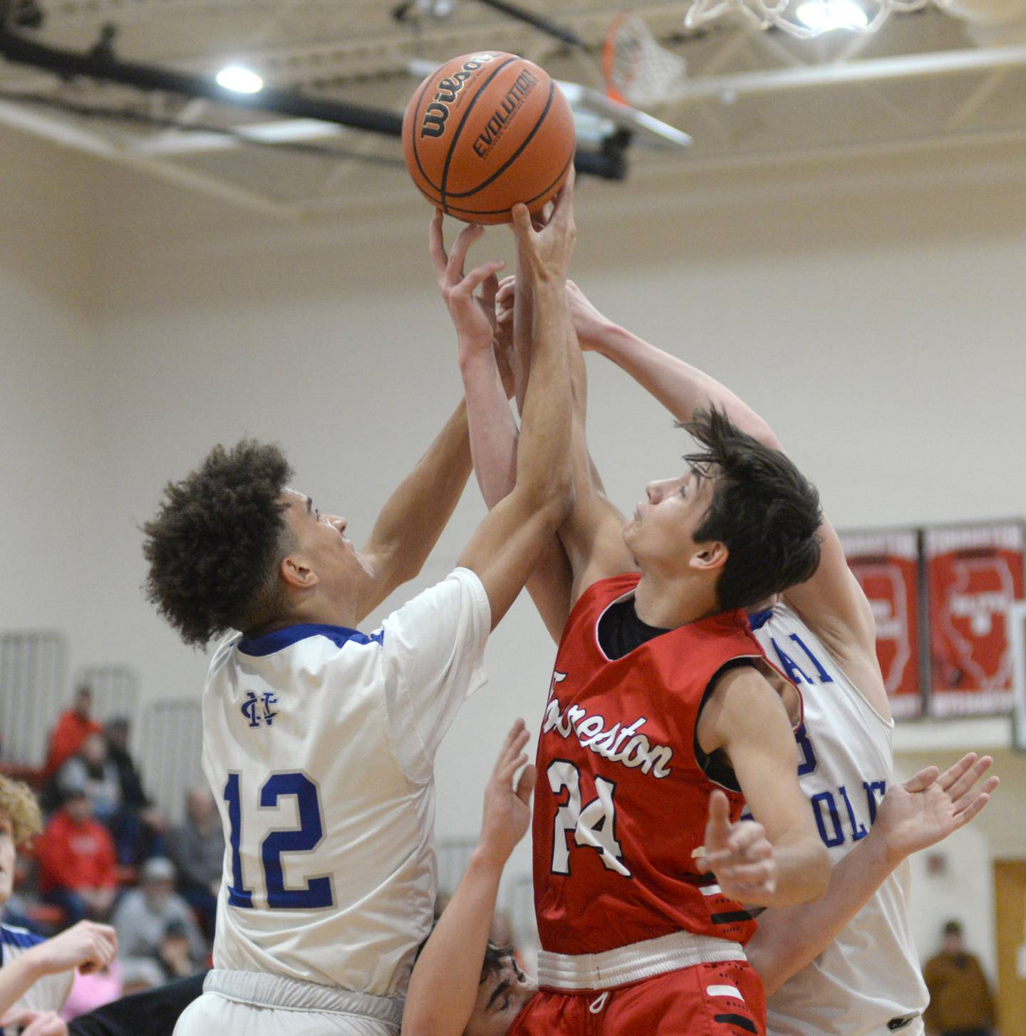 Newman's Isaiah Williams and Forreston's Mickey Probst (left) jump for a rebound at the 62nd Forreston Holiday Tournament at Forreston High School on Saturday, Dec. 16, 2023.