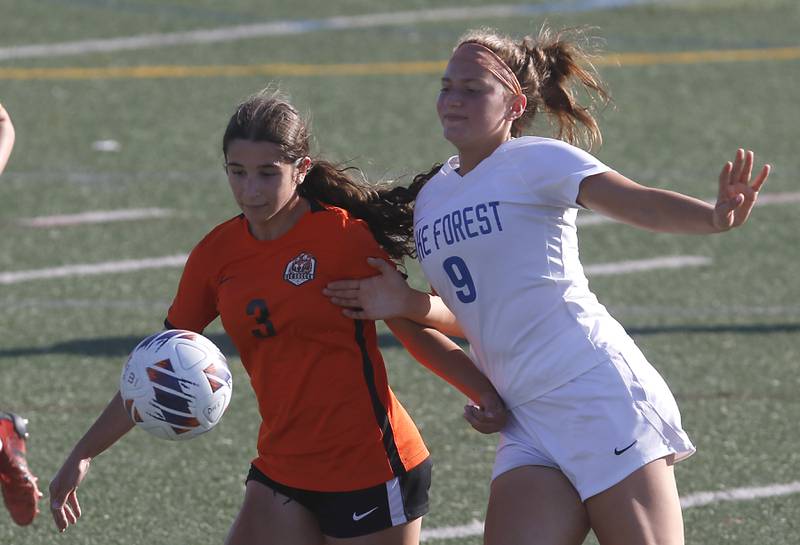 Crystal Lake Central's Addison Schaffer tries to beat Lake Forest's Ryan Rice to the ball during a Class 2A Deerfield Sectional semi-final match on Tuesday, May 21, 2024, at Deerfield High School.