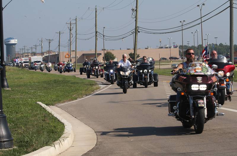 Vietnam Veterans, volunteers and other dignitaries ride in motorcycles lead a procession down Peoria Street for the Vietnam Traveling Memorial Wall on Thursday, Aug. 24, 2023 on in Peru.