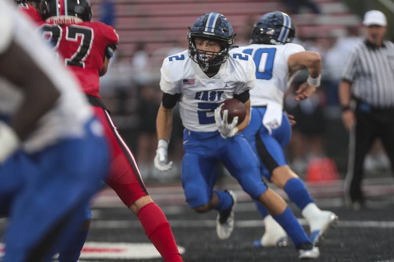 Lincoln-Way East running back James Kwiecinski follows a block out of the backfield on Friday, Sept. 24, 2021, at Bolingbrook High School in Bolingbrook, Ill.