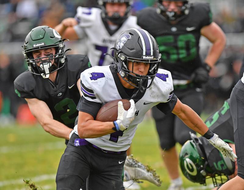 Downers Grove North’s Caden Chiarelli (4) drives into the end zone with his second touchdown during a Class 7A second-round playoff game against Glenbard West on November 8, 2025 at Glenbard West High School in Glen Ellyn.