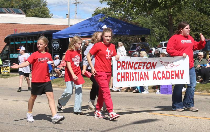 Kids with Princeton Christian Academy hold a banner while walking during the 54th annual Homestead Festival parade on Saturday, Sept. 6, 2025 in Princeton.