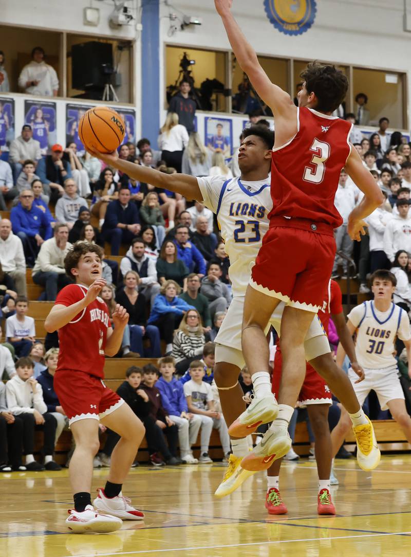 Lyons Township's Blake Ragsdale (23) puts up a shot during a varsity basketball game between Hinsdale Central and Lyons Township high schools on Friday, Dec. 12, 2025 in La Grang