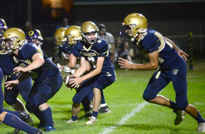 Polo quarterback JT Stephenson looks to hand the ball off during Friday, Oct. 3, 2025 action against Orangeville at Polo High School.