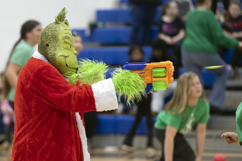 Pulling out a Nerf gun from his back of tricks, Grinch fires on “Team Nice” Saturday, Nov. 23, 2024, in Rock Falls.