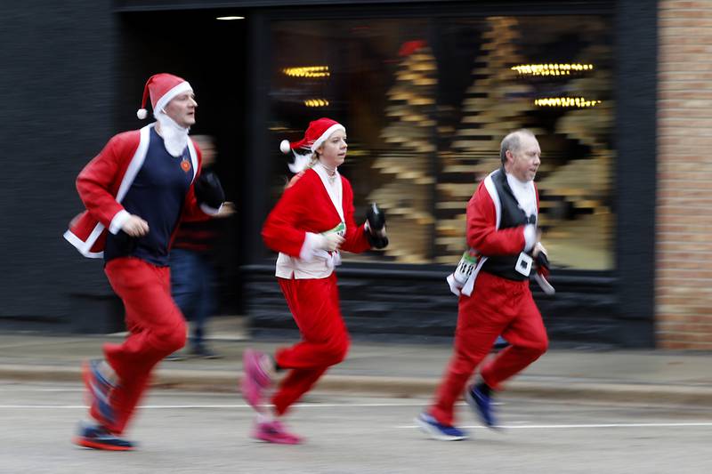 Santa’s runs to the finish line during the McHenry County Santa Run For Kids on Sunday morning, Dec. 3, 2023, in Downtown Crystal Lake. The annual event raises money for agencies in our county who work with children in need.