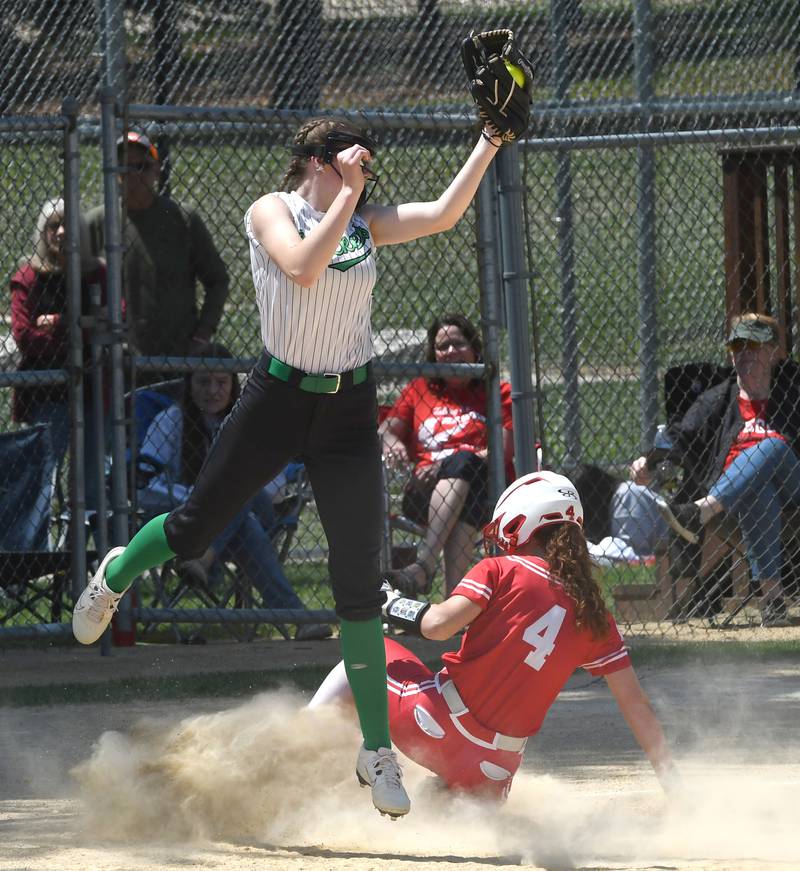 Rock Falls third baseman Rylee McFadden jumps to catch a throw as Oregon's Ashlee Mundell slides safely to the bag during the championship game of the 2A Oregon Regional on Saturday, May 23, 2026 at Oregon Park West.