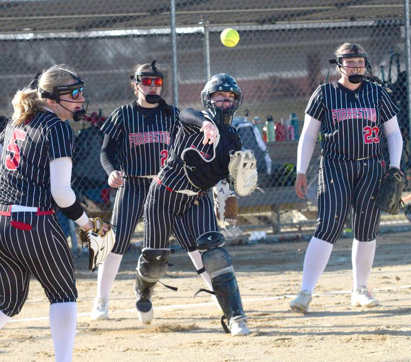Forreston catcher Maddie Chesnek fields a bunt and throws to first against River Ridge/Scales Mound on Monday, March 24, 2025 in Forreston. Also pictured are Alivia Ingram (5), Alice Kobler (24), and Aubrey Sanders (23). The Cardinals lost the game 8-4.