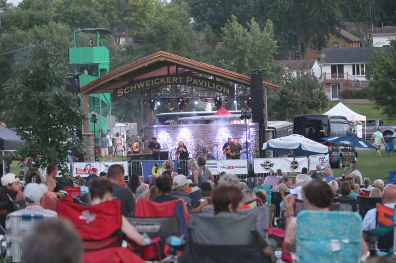 A large crowd watches the World Turning Band, a Fleetwood Mac tribute band perform underneath the Schweickert Pavilion during the Taste of the Illinois Valley festival on Saturday, Aug. 3, 2024 at Centennial Park in Peru.