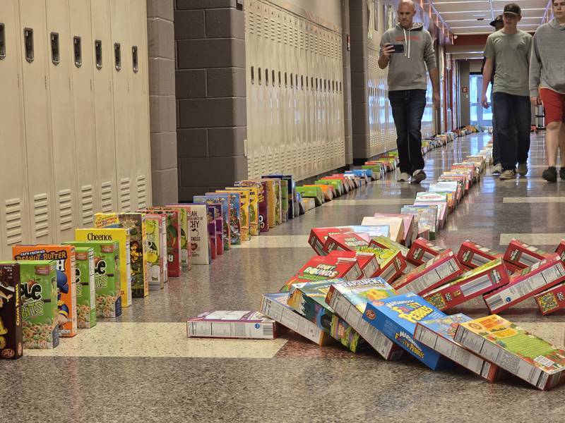 Streator FFA instructor captures on video the cereal boxes as they tumble Tuesday, March 18, 2025, in the hallways of Streator High School.